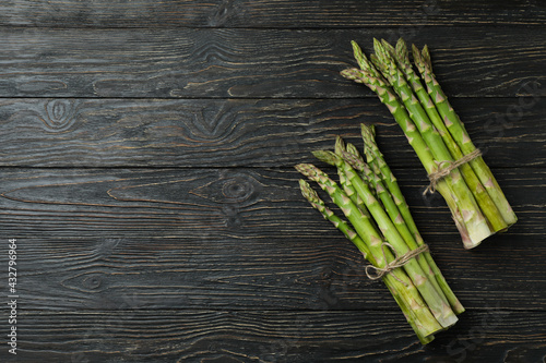 Bunches of green asparagus on wooden background