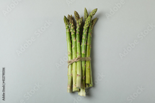 Bunch of fresh asparagus on light gray background
