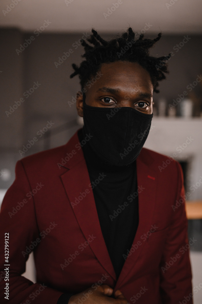 portrait of an afro american in a suit wears a black medical mask portrait of an afro american in a suit wears a black medical mask