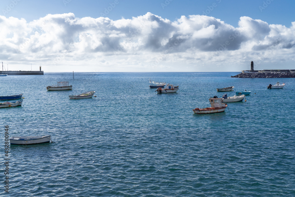many small fishing boats and row boats in the water many small fishing boats and row boats in the water
