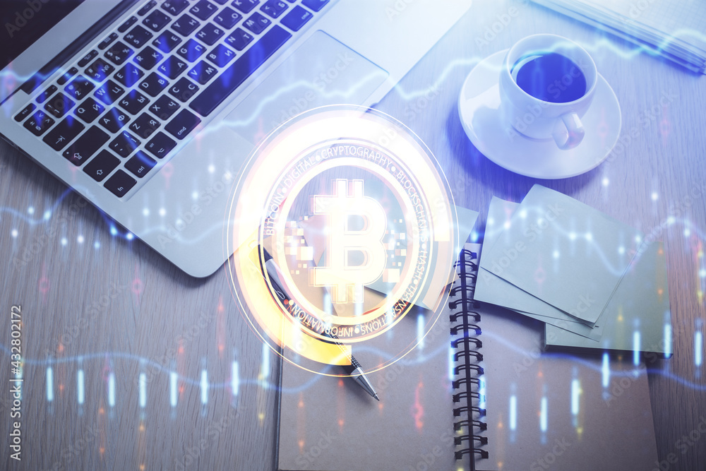 Blockchain theme hologram drawings over computer on the desktop background. Top view. Double exposure. Blockchain theme hologram drawings over computer on the desktop background. Top view. Double exposure.