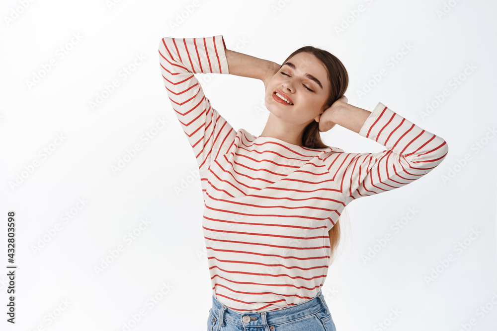 Beautiful smiling woman resting, holding hands behind head and close eyes, lying with dreamy smile and happy carefree expression, enjoying holidays, standing over white background Beautiful smiling woman resting, holding hands behind head and close eyes, lying with dreamy smile and happy carefree expression, enjoying holidays, standing over white background