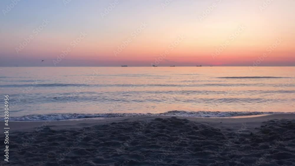 Peaceful sunrise on the beach, early morning, sea waves Peaceful sunrise on the beach, early morning, sea waves
