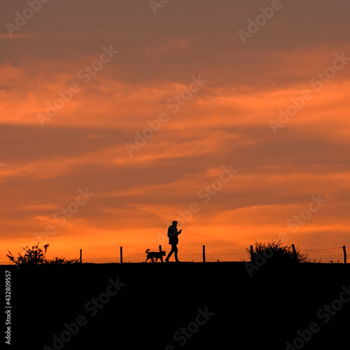 people walking in the country with a beautiful sunset