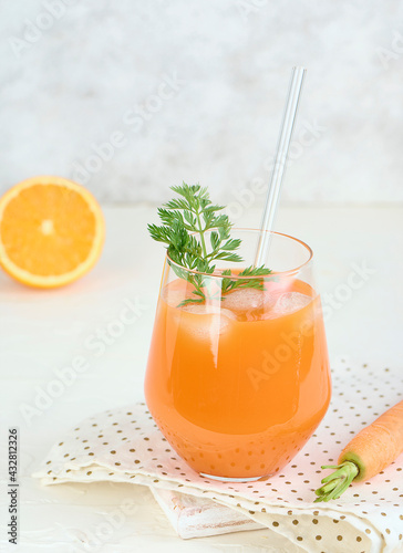 Glass of carrot juice smoothie in lifestyle scene. Copy concept.