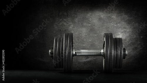 Dumbells on dark desk and free space for your decoration 