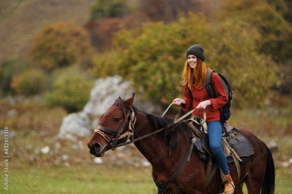 woman hiker riding a horse on nature mountains adventure woman hiker riding a horse on nature mountains adventure