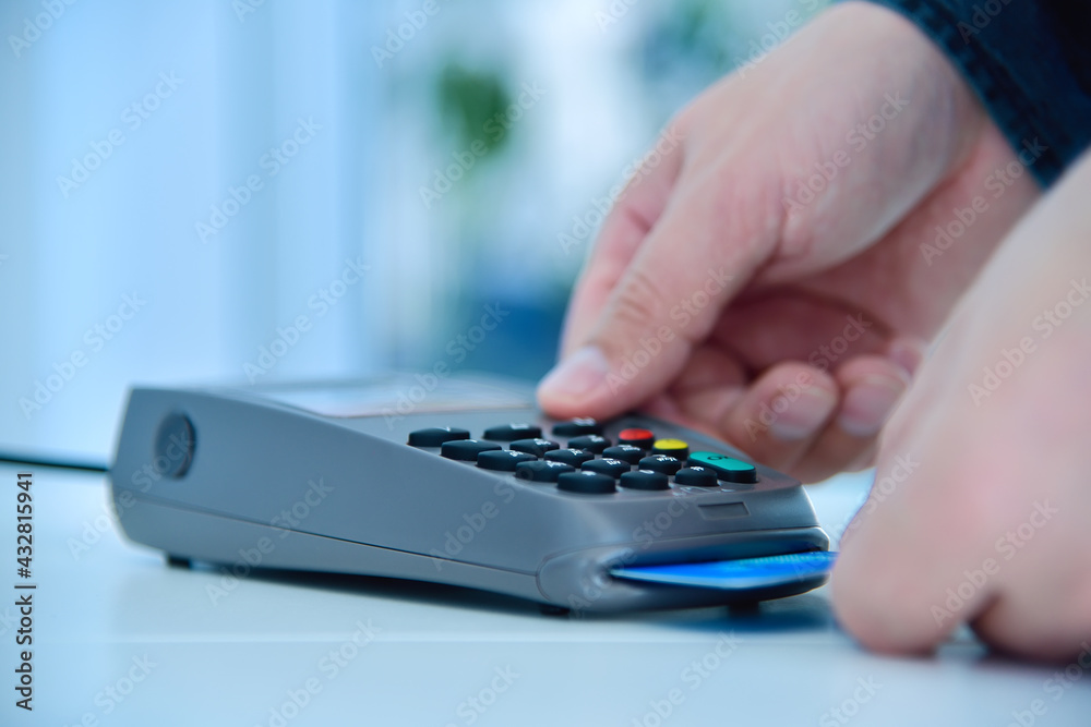 Hand makes payment by blue credit card Hand makes payment by blue credit card