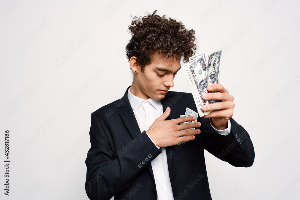 man in a suit a bundle of money in the hands of a businessman self-confidence man in a suit a bundle of money in the hands of a businessman self-confidence