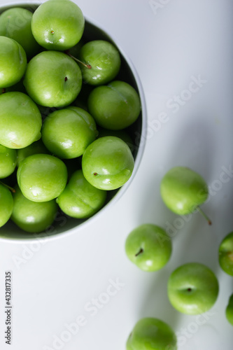 Wallpaper Mural Fresh green plums in a white bowl. Top view. Torontodigital.ca