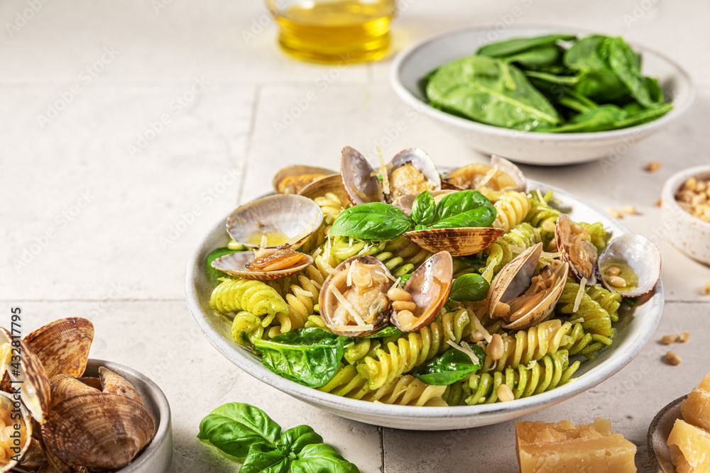 Seafood pasta salad with vongole clams, fusilli, spinach, parmesan cheese, pine nuts and basil. Healthy food Seafood pasta salad with vongole clams, fusilli, spinach, parmesan cheese, pine nuts and basil. Healthy food