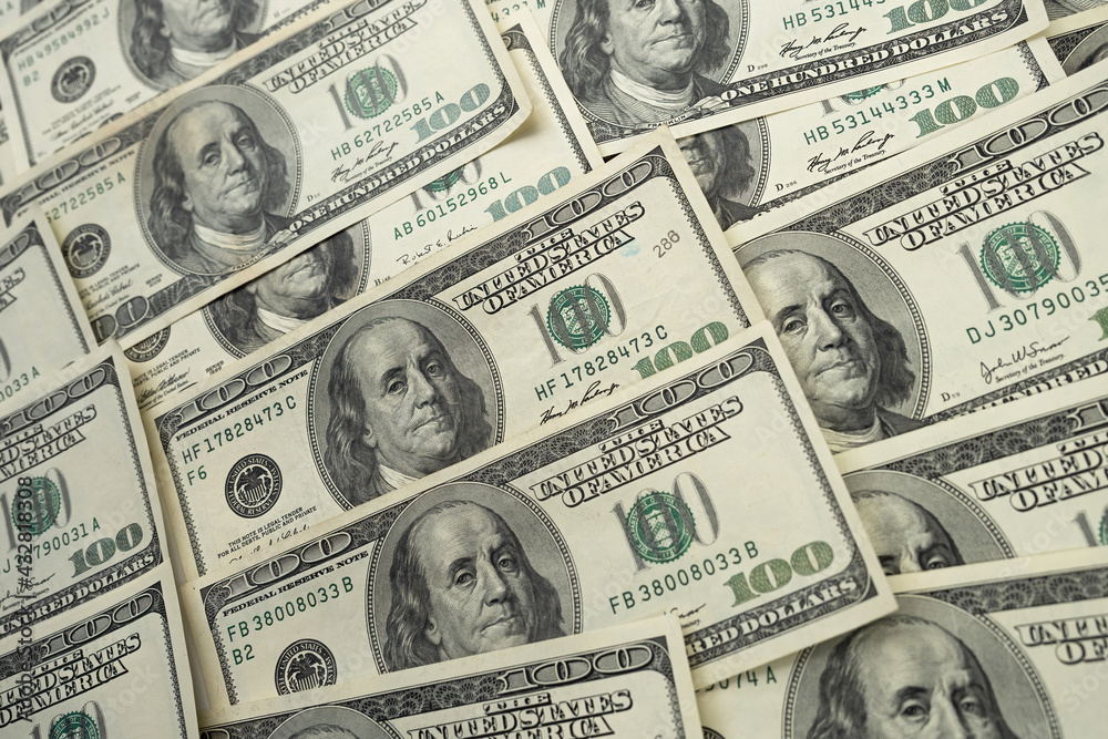 A money pile of one hundred US banknotes with president Franklin portrait. Cash of hundred dollar bills, paper currency background. A money pile of one hundred US banknotes with president Franklin portrait. Cash of hundred dollar bills, paper currency background.