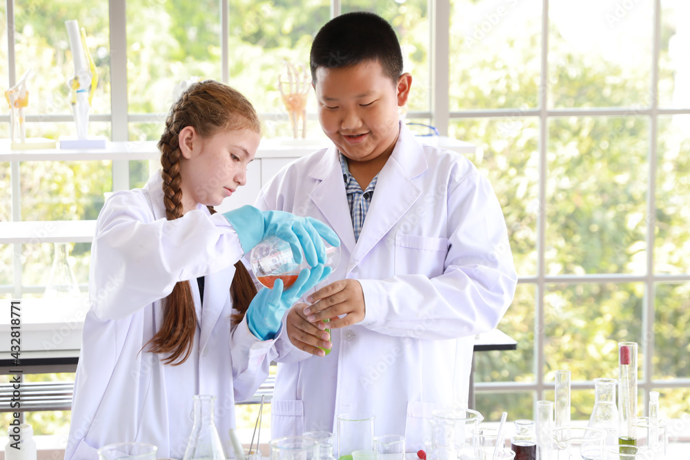 happy kids making science experiments. (education and scientist concept)