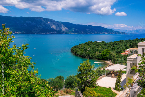 Beautiful summer landscape with sea resort -turquoise colored calm water, mountains and beach. Corfu Island, Greece