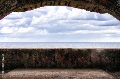 view of the sea from the opening of a bunker on the shore photo