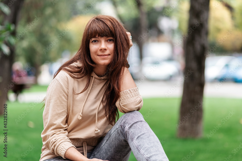 Portrait of a young caucasian woman posing in a park Portrait of a young caucasian woman posing in a park