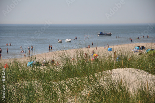 Die Dünenlandschaft am Weststrand Norderney und Meerblick: grüne Dünenlandschaft mit Nordsee und Tourismus photo