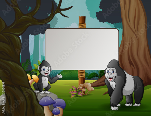Cute a gorilla with her cub standing near the blank sign