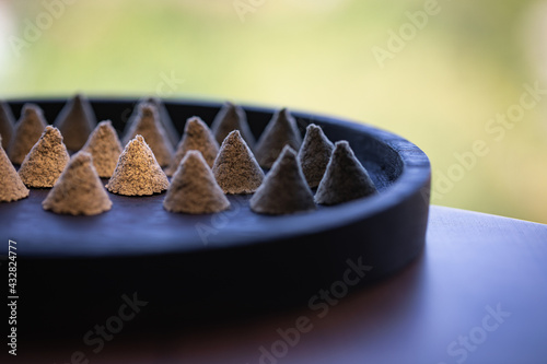 Photos The conical moxa used for treatment is placed in a wooden dish