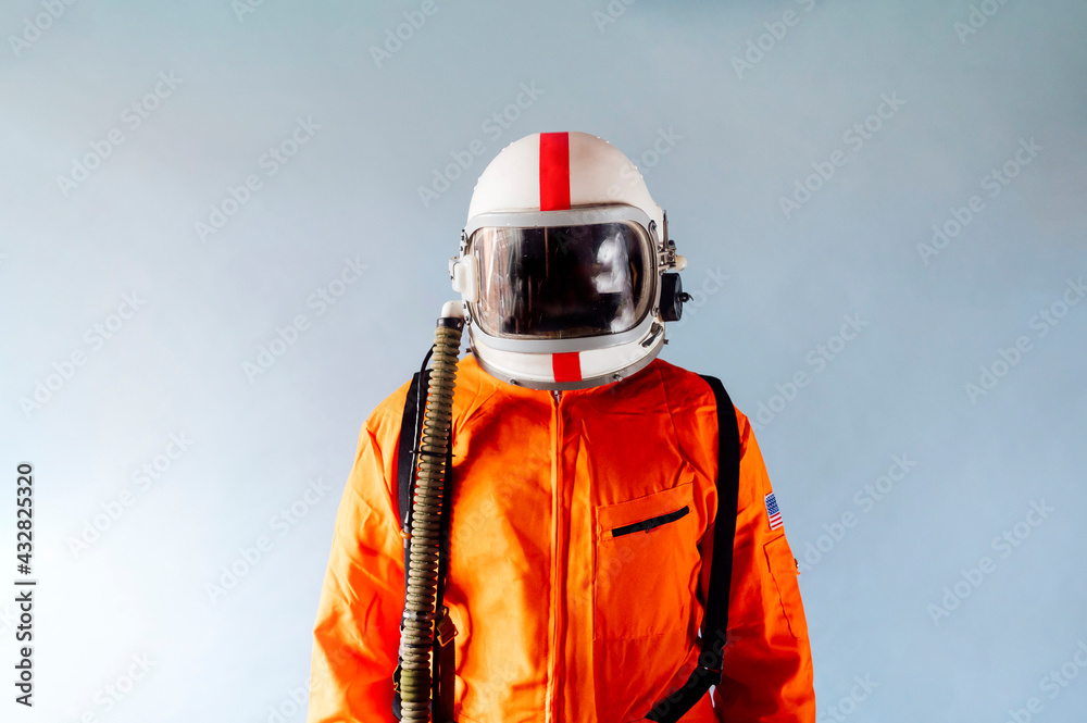 Unrecognizable man in orange astronaut suit. Unrecognizable man in orange astronaut suit.