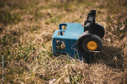 broken children's car in the grass