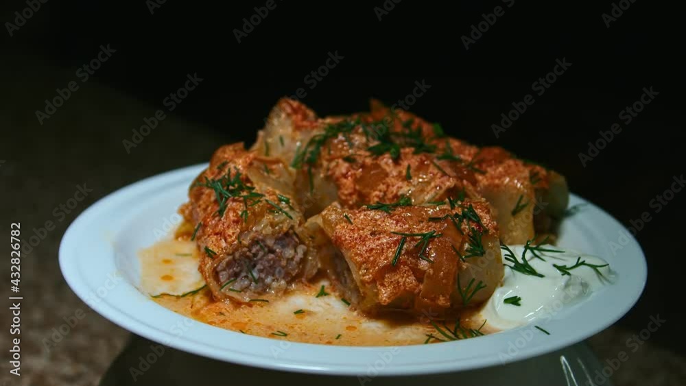 Minced meat stew in cabbage leaves, in the form and on a plate, play with light, presentation of the dish Minced meat stew in cabbage leaves, in the form and on a plate, play with light, presentation of the dish