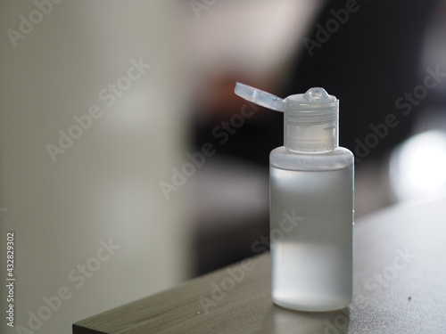 Hand Sanitizer, gel alcoholic mixture with gelatin in clear Plastic bottle with pump pushing wash clean dirty to prevent germs protect Contagious disease coronavirus covid-19, on the table photo