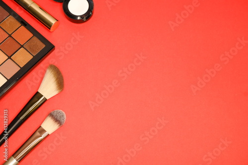 Cosmetics on a stylish red background. Makeup.