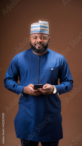 Portrait of bearded Nigerian man using a mobile phone  © Terver