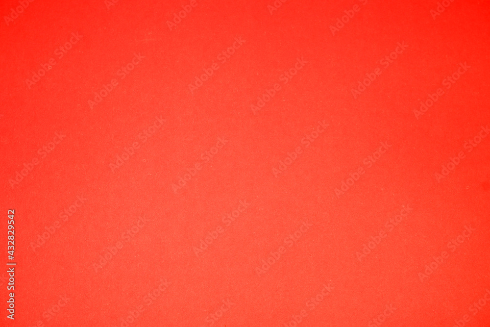 Stylish red background. The texture of the cardboard.