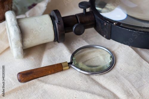 Group of old vintage retro loupes magnifier on canvas top view, searching concept