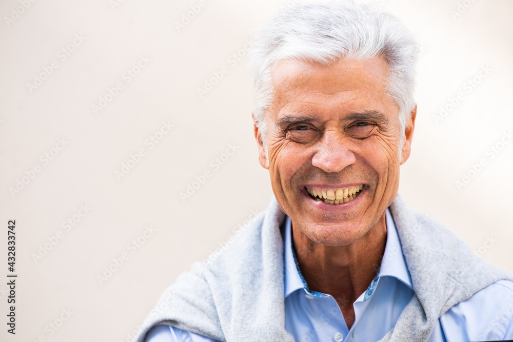 Close up smiling older man against white background copy space Close up smiling older man against white background copy space