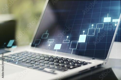 Double exposure of abstract creative financial chart on modern laptop background, research and strategy concept
