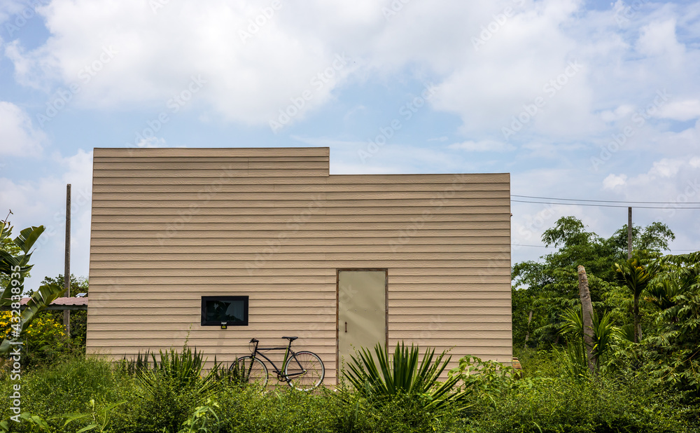 Modern cream house amid a small forest garden. Modern cream house amid a small forest garden.
