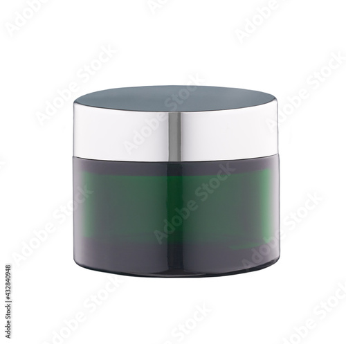 Green glass jar of beauty cream with silver cap isolated on white background.