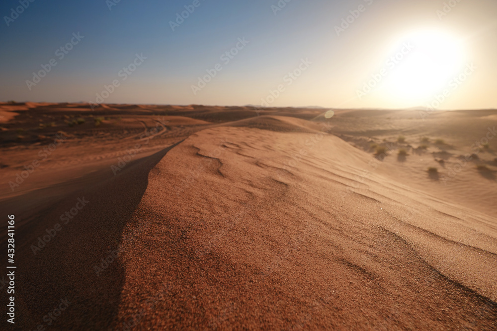 Sunset over the sand dunes in the desert.