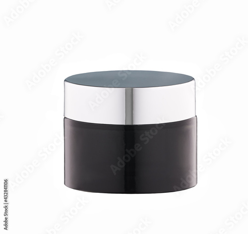 Black glass jar of beauty cream with silver cap isolated on white background.