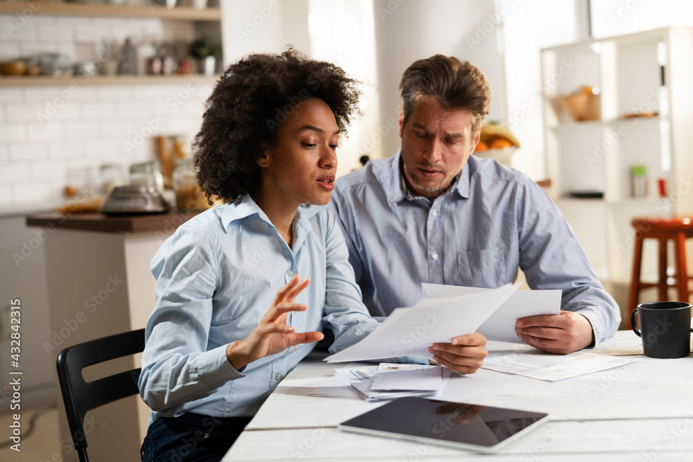 Young couple preparing bills to pay. Stressed woman and man having financial problems.. Young couple preparing bills to pay. Stressed woman and man having financial problems..
