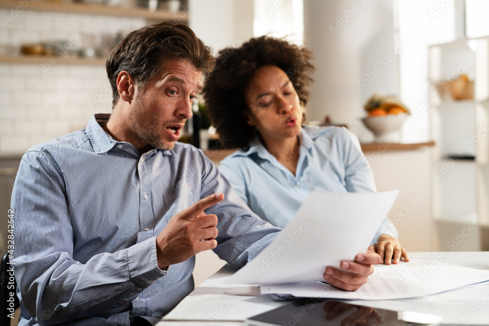 Young couple preparing bills to pay. Stressed woman and man having financial problems.. Young couple preparing bills to pay. Stressed woman and man having financial problems..