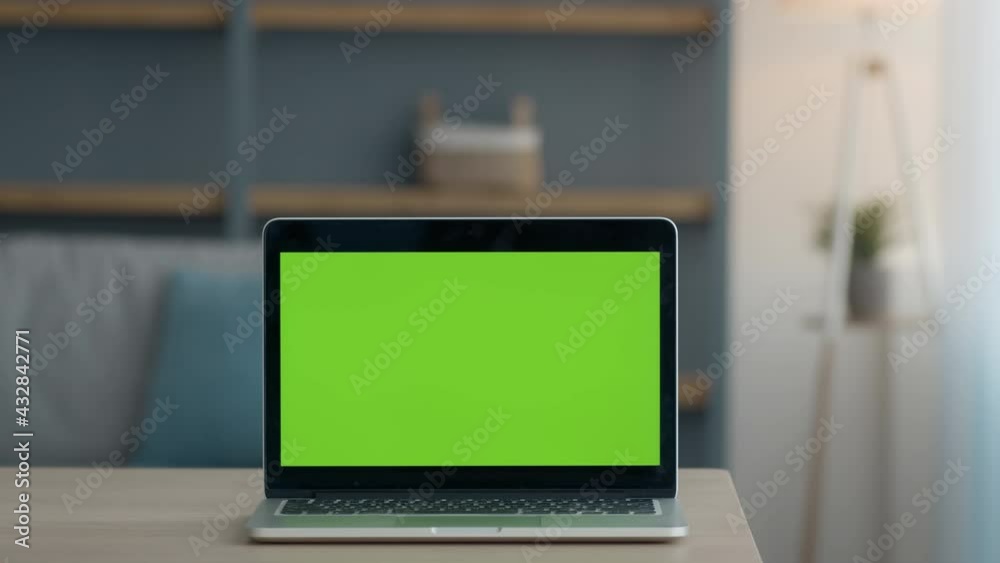 Zoom in shot of modern laptop with green chroma key screen, mockup for text, application or website