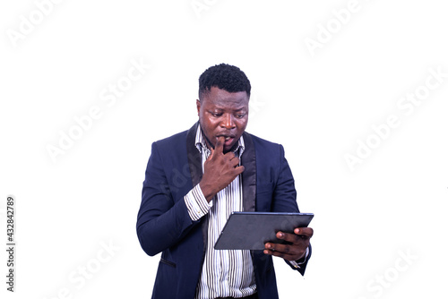 handsome young surprised businessman looking at digital tablet screen.