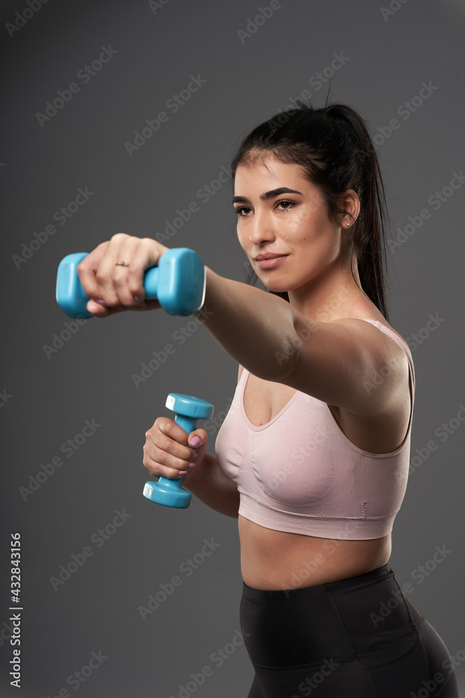 Plus size woman doing fitness exercises with dumbbells Plus size woman doing fitness exercises with dumbbells