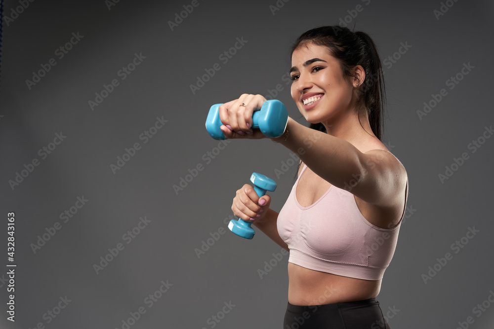 Plus size woman doing fitness exercises with dumbbells Plus size woman doing fitness exercises with dumbbells