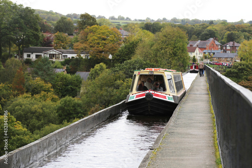 Tela A canal boat navigating the Llangollen canal across the Pontcysyllte aqueduct in the Dee Valley