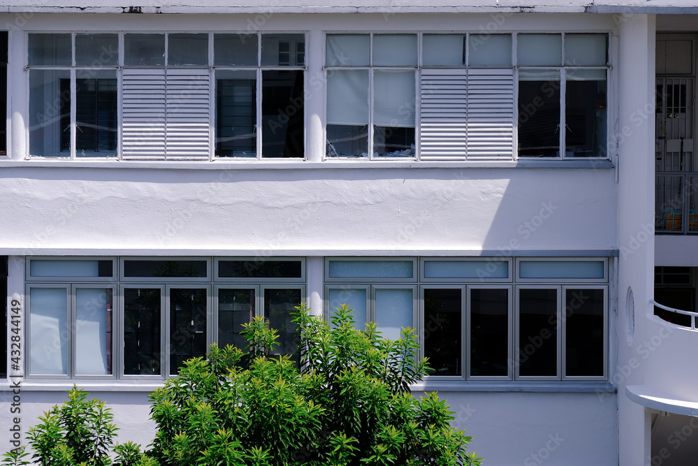 Common exterior view of old public housing featuring many windows, Tiong Bahru heartland estate. The art deco inspired architecture of old flats are very popular and the property highly sought after.