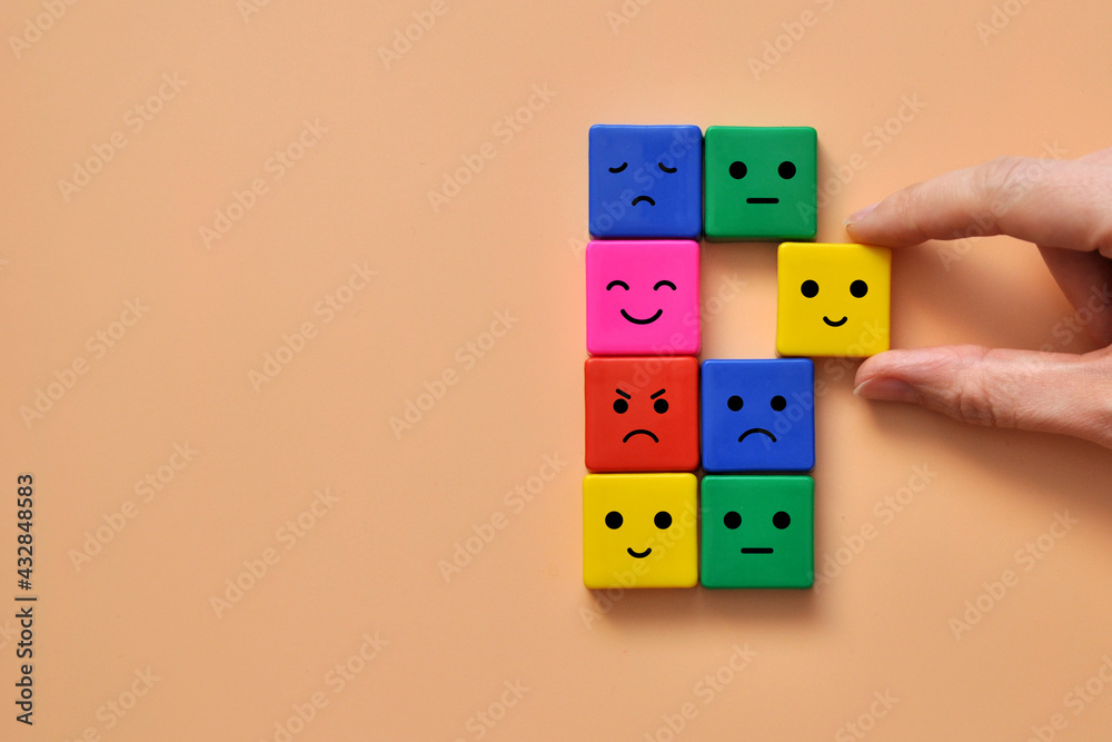 Colorful cubes with drawings of various emotions: sadness, anger, calmness. Emotions in a person's life. Choosing the joy of life Colorful cubes with drawings of various emotions: sadness, anger, calmness. Emotions in a person's life. Choosing the joy of life