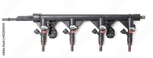 Fotografie, Tablou Close-up on a car fuel rail with injectors for supplying gasoline to a four cylinder engine on a white isolated background