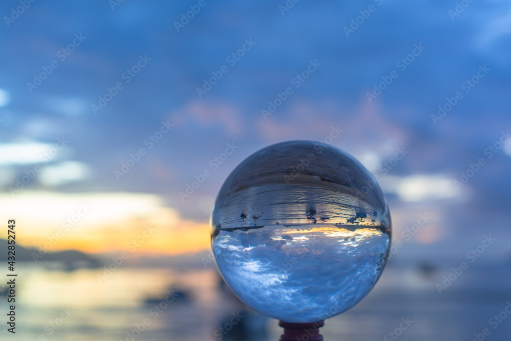 sunset sunrise view inside crystal ball..The natural view of the sea and sky are unconventional and beautiful. .A image for a unique and creative travel idea. sunset sunrise view inside crystal ball..The natural view of the sea and sky are unconventional and beautiful. .A image for a unique and creative travel idea.