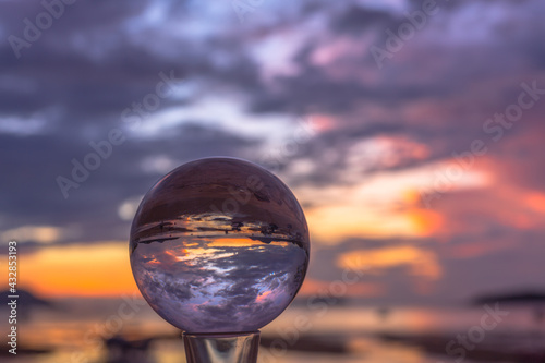 sunset sunrise view inside crystal ball..The natural view of the sea and sky are unconventional and beautiful. .A image for a unique and creative travel idea.