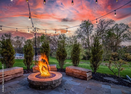 Luxury home during twilight golden hour with pink and purple sky and lush landscaping in Nebraska USA